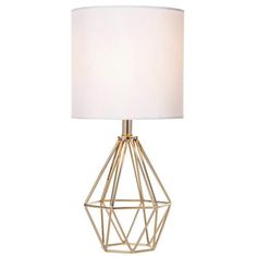 a table lamp with a white shade on the base and a gold metal cage design