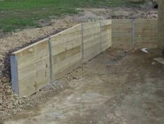 a wooden fence in the middle of a yard