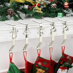 christmas stockings hanging from hooks in front of a fireplace