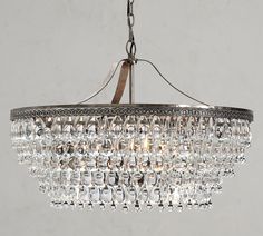 a chandelier hanging from the ceiling with clear crystal drops on it's sides