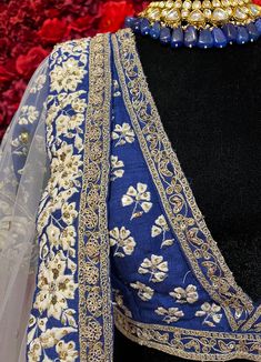 Subtle hues of whimsy blend with floral embroideries in this Royal Blue lehenga. The mehreen lehenga, embroidered with beautiful floral motifs and golden embroidery work, looks every bit of the royal self! Color - Fabric & Work Style -- Silk lehenga: Rich embroidery, floral embroidery work.- Silk embroidered blouse.- Net dupatta. Details -- Assured quality.- Wash care instruction: Dry clean only.- Slight variation in color is possible due to digital photography. Elegant Lehenga With Floral Embroidery In Traditional Drape, Elegant Embroidered Choli With Traditional Drape, Elegant Lehenga With Floral Embroidery, Unstitched Lehenga With Intricate Embroidery For Festive Occasions, Festive Lehenga With Intricate Embroidery Unstitched, Intricate Embroidery Raw Silk Sharara For Reception, Designer Raw Silk Lehenga With Resham Embroidery, Designer Resham Embroidered Raw Silk Lehenga, Festive Unstitched Lehenga With Intricate Embroidery