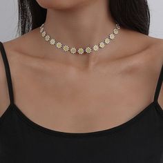 Introducing our exquisite and delicate daisy flower choker, adorned with charming, vibrant daisies that gracefully embellish the necklace. The chain is expertly crafted from a premium alloy with a lustrous gold finish, ensuring both durability and elegance. Its adjustable closing allows for a customized fit, making it the ideal accessory. --WHATS INCLUDED?--- 1x - Daisy Flower Choker Necklace Length: 34cm + (4.5cm adjustable length) --TURNAROUND TIME-- Once you've placed your order, we immediate Sunflower Design Floral Jewelry, Spring White Clavicle Chain Jewelry, Elegant Daisy Shaped Jewelry, White Flower Jewelry With Sunflower Design, White Flower-shaped Jewelry With Sunflower Design, Spring Choker Jewelry, White Sunflower Design Flower Jewelry, Summer Flower Necklace With Flower Charm, Summer Flower Necklace With Charm