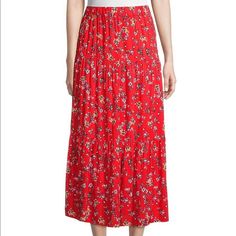 a woman wearing a red floral print skirt