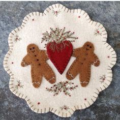 two gingerbreads and a heart on a doily