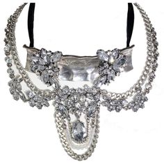 Choker style necklace with antique design and crystal rhinestone embellishments. Glamorous Silver Metal Choker, Glamorous Silver Choker With Jewels, Costume Jewelry Crystal Necklace With Jewels, Silver Rhinestone Choker Crystal Necklace, Silver Rhinestone Crystal Choker Necklace, Silver Crystal Choker With Chain, Party Crystal Necklaces With Jewels, Glamorous Metal Crystal Necklace With Bling, Glamorous Silver Crystal Choker Necklace