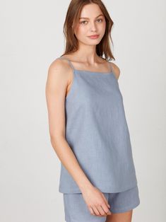 "AMBER is a simple linen strap top with a square neckline. DETAILS - Sleeveless design - Spaghetti straps - Square neckline - Oeko-Tex certified 100% local washed midweight linen - Cut and sewn to order just for you in our studio COLOR - Vista Blue, you can also choose other colors above - Fabric samples are available here https://www.etsy.com/listing/586569696/linen-fabric-samples SIZING & FIT - True to size - Model is 5'10\" / 178cm and wearing a size XS CARE FOR LINEN - Machine wash up to 30ºC/86ºF gentle cycle - Lay flat to dry or tumble dry low - Warm iron if needed - Do not bleach SIZE GUIDE Size conversion guide Size XS (US 0-2, IT 36-38, UK 4-6, Japan 3-5, France 32-34) Size S (US 4-6, IT 40-42, UK 8-10, Japan 7-9, France 36-38) Size M (US 8-10, IT 44-46, UK 12-14, Japan 11-13, Fra Summer Cotton Tops With Straight Neckline, Summer Square Neck Top With Adjustable Straps, Cotton Tops With Straight Neckline For Summer, Spring Square Neck Camisole For Everyday, Spring Everyday Camisole With Square Neck, Spring Everyday Square Neck Camisole, Summer Linen Top With Tie Straps, Summer Cotton Camisole With Square Neck, Square Neck Cotton Camisole For Summer