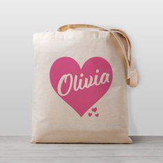 Personalized Tote Bag, Pink Heart, Valentine's Day, Pick your own color for the graphic. These are super popular for daycare or preschool bags. ➡️ Totes are DTG printed and hand pressed using child safe inks in our Nashville Studio. ➡️ You can specify any text/graphic color from our swatch sheet. ➡️ Our lightweight 100% cotton natural canvas totes measure 14.5 by 15.5 inches. The bag is 6 oz lightweight fabric, has fabric handles and no gusset. ➡️ Totes take about 2-3 days to make. During crunch