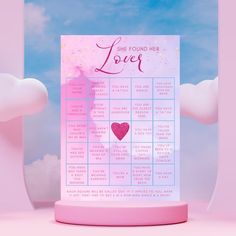 a pink and blue calendar with a heart on it in the middle of some clouds