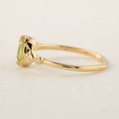 * ≈6x4mm oval peridot * Band width: ≈1.3mm * G color SI diamonds, ≈0.04ctw * Setting style: Prong setting, low profile (sits flush on your finger) * Material: Solid 14k yellow gold, rose gold or white gold * Made of 100% recycled precious metal and ethically sourced gemstone * Comes in a gift box with a bow ready for gifting * Handmade with love and great care in New York * Please note that colors may vary slightly as they are genuine gemstones. Our Dedication All our jewelry is designed and cre Oval Peridot Birthstone Ring For May, Lime Green Peridot Birthstone Ring For Promise, Oval Peridot Birthstone Ring, Peridot Oval Birthstone Promise Ring, Lime Green Peridot Ring For May Birthstone, Oval Peridot Birthstone Ring In Fine Jewelry, Yellow Gold Peridot Diamond Ring With Birthstone, Oval Peridot Birthstone Promise Ring, Lime Green Peridot Birthstone Ring For May