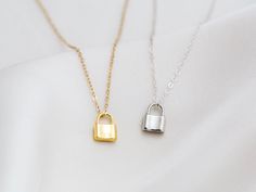 "Dainty lock necklace! The pendant is made of gold vermeil, which is heavy gold plating over sterling silver. Pair it with your favorite outfit! Layer with other necklaces, by or wear itself for a pop! . . . . . . . . . . . . . . . . . . . . . . . . . . . . . . . . . . . . . . . . . . NECKLACE + Length: 16\" + 2\" extender + Vermeil (18k gold plating over sterling silver) -or- sterling silver lock pendant: 8mm x 11mm + 14k gold filled -or- sterling silver chain, spring clasp, & findings LAYE Silver Chain Necklace With Lock For Gifting, Silver Lock Chain Necklace As A Gift, Silver Chain Necklace With Lock For Gift, Silver Lock Necklace Gift, Silver Necklace With Lock Gift, Silver Necklace With Lock As Gift, Gold Chain Necklace With Lock For Gift, Gold Lock Necklace As Gift, Yellow Gold Necklace With Lock As Gift