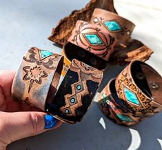 Hand Tooled Leather Cuff Bracelets These are all one-of-a-kind, slowly hand tooled in my workshop and hand painted with great detail!  A rugged and weathered finish adds a dash of Western Boho to your outfit! The turquoise focal points are painted to look like a chunk of turquoise stone.  Each bracelet was slowly made entirely by hand.  This means each and every bracelet will have slight differences because they're handmade, not machine made! These are ready to ship! These cuffs features Top Qua Luxury Hand Tooled Brown Bracelet, Luxury Southwestern Stamped Cuff Bracelet, Boho Leather Jewelry, Hand Painted Ring, Leather Cuff Bracelets, Leather Wrist Cuff, Western Bracelets, Handmade Leather Bracelets, Leather Wristbands