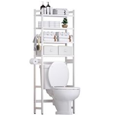 a white toilet sitting next to a shelf filled with towels and other bathroom items on top of it