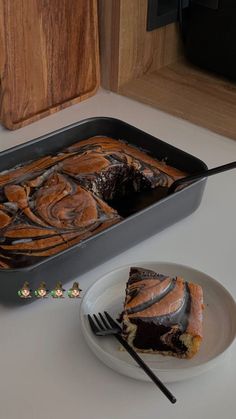 a piece of cake sitting on top of a plate next to a knife and fork