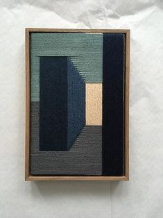 an abstract painting in wood frame on white paper