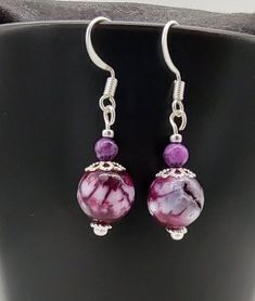 These purple and silver earrings are  a pretty , lightweight  accessory that you can wear with your every day attire . They would also make a great gift! Earring measures approximately 2 inches long. Ready to ship.  Attention! Colors may look different depending on your monitor settings.  Jewelry Care:  To keep the materials in your jewelry in good condition, do not wear while swimming, bathing, or heavily exercising. Avoid contact with abrasive or sharp objects, water, oils, lotions, perfume, chemicals, and excessive perspiration, as these things may alter bead finishes or cause damage to the materials in your jewelry. Elegant Lavender Beaded Drop Earrings, Elegant Lavender Beaded Earrings, Nickel-free Purple Beaded Earrings, Nickel-free Purple Beaded Earrings With Round Beads, Purple Nickel-free Earrings For Gift, Nickel-free Purple Earrings As Gift, Nickel-free Round Purple Earrings, Hypoallergenic Purple Round Bead Earrings, Hypoallergenic Purple Beaded Earrings