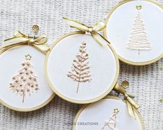 three embroidered christmas ornaments with bows on them