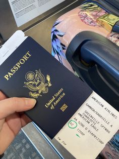 a person holding up a passport in their hand