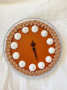 a cake with white frosting on it sitting on a table