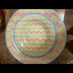 a colorful plate sitting on top of a counter next to a knife and fork,