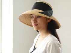 "I just adore classic movie stars wearing their hats so elegantly. This Casablanca style hat, \" Holly\", is inspired by those classic movies, and also added modernity for today. The wide brim is nicely curved to the end, covers perfectly your face from sunshine. Material is natural, narrow good quality straw, which you hardly find in mass products nowadays. Please chose ribbon colour black, white, beige and grey. I attached the ribbon to the side by sewing. If you wish to show in the front or b Elegant Straw Visor Hat, Elegant Adjustable Panama Visor Hat, Elegant Adjustable Panama Hat With Visor, Elegant Boater Hat With Visor For Spring, Elegant Spring Boater Hat With Visor, Elegant Visor Sun Hat For Kentucky Derby, Elegant Summer Panama Visor Hat, Elegant Visor Sun Hat For The Kentucky Derby, Classic Panama Hat For Kentucky Derby Garden Party