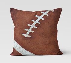 an old football pillow on a white background