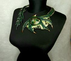 This is a unique necklace crafted from genuine leather, painted with acrylics, with hand-painted dragon eye , this unique necklace will protect you from ill will and will give you compliments from anyone who sees it. To see more of my products visit my page in Instagram https://www.instagram.com/mariyana.sobol Adjustable Fantasy Necklaces For Fantasy Events, Adjustable Fantasy Necklace For Fantasy Events, Handmade Fantasy Choker For Festivals, Handmade Fantasy Festival Choker, Unique Adjustable Dragon Design Jewelry, Adjustable Unique Jewelry With Dragon Design, Handmade Halloween Choker Jewelry, Fantasy Necklaces For Halloween Festival, Fantasy Pendant Jewelry For Fantasy Events