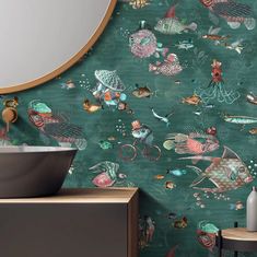 the bathroom is decorated with colorful wallpapers and an oval mirror above the sink