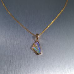 Solid carved Lightning Ridge crystal opal, set in a 14ct yellow gold pendant.  Chain not included. Opal Weight: 2.0ct Size: 16x8.8mm Pendant Length: 26mm Width: 10mm Depth: 4.5mm Materials: Lightning Ridge solid opal, 14ct yellow gold   Total Weight: 1.6gm Gold Opal Birthstone Ring As Gift, Fine Jewelry Opal In Gold, Gold Opal Fine Jewelry, Fine Gold Opal Jewelry, Formal Opal Pendant Jewelry, Iridescent Opal Jewelry For Anniversary, Polished Opal Pendant Jewelry, Opal Cabochon Yellow Gold Jewelry, Fine Jewelry Opal In Yellow Gold