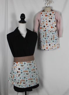 two aprons that are on top of a mannequin