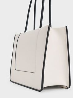 This product is made with at least 20% sustainable materials by weight. CHARLES & KEITH uses recycled, degradable, organic, and water-based materials in our eco-conscious collection. The Daylla tote bag is stylish and practical at the same time. The two-toned black-and-white design is simple yet striking, and will go well with everything in your wardrobe. Featuring double handles and a zip closure, the Daylla lets you access your belongings easily while keeping them safe and secure. It is perfect for everyday use. Size Chart For Kids, Brand Collaboration, Charles Keith, Handbags Online, Black And White Design, Printables Kids, Sustainable Materials, Online Bags, Belt Size