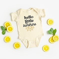 The perfect bodysuit for your perfect baby! These short sleeve bodysuits have 3 snap closure and double needle ribbed binding on neck, shoulders, sleeves, and leg openings. Machine wash cold, inside out. Air dry or tumble dry low. Basic Cotton Short Sleeve Bodysuit For Summer, Yellow Short Sleeve Bodysuit For Spring, Spring Yellow Short Sleeve Bodysuit, Fitted Cotton Onesie For Beach, Cute Yellow Cotton Bodysuit, Fitted Basic Summer Onesie, Basic Fitted Summer Onesie, Summer Basic Fitted Onesie, Playful Cotton Bodysuit With Letter Print