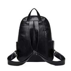 a black leather backpack with zippers on the front and side pockets, sitting against a white background