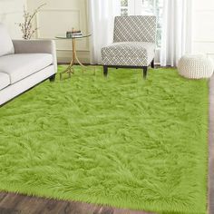 a living room with a white couch and green rug