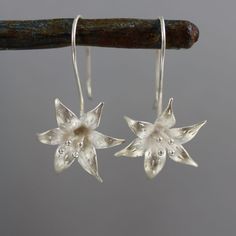 Selling for a friend (I did not make these): Silver flower earrings.  Silver flowers similar to day lilies are dangling from sterling silver hook posts.  The flowers are 18mm wide and from top to bottom they measure 1-1/3 inches. Flower Earrings Silver, Sterling Silver Flower Earrings, Boulder Creek, Day Lilies, Silver Flower Earrings, Sterling Silver Flowers, Silver Flowers, Earrings Sterling Silver, Earrings Silver