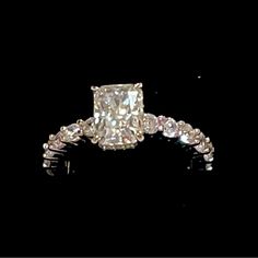 a fancy diamond ring on a black background