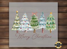 christmas trees are painted in watercolor on wood