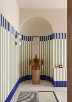 a bathroom with blue and white stripes on the walls