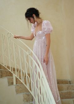 Allow us to introduce you to the Fairydust Maxi—a pink sequin masterpiece adorned with ethereal bubble sleeves that will transport you to a realm of pure, romantic whimsy. With a gown like this, every step is a glistening waltz, every shimmering glance a stolen moment, and every touch a promise of forever. U- wire neckline Elasticated ruffled sleeves Empire Waistline Fully gathered skirt Fit and flare style Invisible zipper at back seam Sequin 100% polyester Lining is Viscose Georgette Hand wash Empire Waistline, Top Skirt Set, Skirt Fits, Pink Sequin, Gathered Skirt, Ruffled Sleeves, Waltz, Invisible Zipper, Beauty Secrets