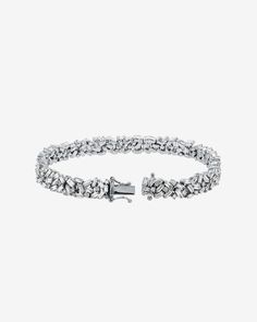 Our Classic Diamond Midi Sparkler Tennis Bracelet is a true masterpiece, designed to dazzle. Expertly handcrafted in 18-karat gold and set with an 6.20 carats of baguette and round white diamonds, this bracelet is the epitome of luxury and elegance. Details 18k white gold 6.20 carats of baguette white diamonds Bracelet measures 7" inches in length Box clasp with safety lock fastening 7mm width Ref: AKB303 Luxury Platinum Diamond Bracelet With Baguette Diamonds, Diamond White Platinum Bracelet With Baguette Diamonds, Platinum Diamond Bracelet With Baguette Diamonds In Diamond White, Diamond White Baguette Cut Platinum Bracelet, Platinum Diamond Bracelet With Baguette Cut, Platinum Diamond Bracelet With Brilliant And Baguette Cut, White Gold Baguette Diamond Bracelet, Luxury Diamond Bracelet With Baguette Cut Single Diamonds, Luxury Diamond Bracelet With Baguette Cut