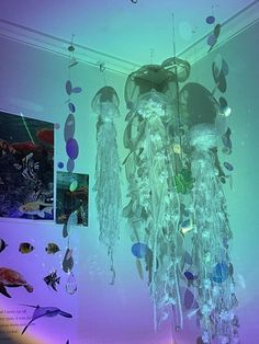 a chandelier hanging from the ceiling in a room filled with fish and sea life