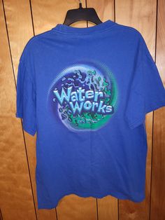 "Vintage 1997 Kings Dominion Amusement Park T shirt Water Works - Water park inside the amusement park (Outside Richmond, Virginia) short sleeve, crew neck as seen graphics on each side Paramount Parks Tag Vintage Fashion t shirt Size: Tag says - LARGE Measurements: when item is Flat on table Pit to Pit (Across Chest): roughly 21\" Length (Top of Collar to Hem): roughly 29'' Material: cotton Color: Blue Condition: The item is vintage in pre-owned condition. shows some light wear all over, a few 90s Style Blue Short Sleeve T-shirt, Cheap Vintage Blue T-shirt, Blue Vintage T-shirt With Relaxed Fit, 90s Inspired Blue Cotton T-shirt, 90s Blue Logo Print T-shirt, 90s Blue Short Sleeve T-shirt, Kings Dominion, Vintage Blue T-shirt With Front Print, 90s Blue Sports T-shirt