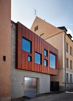 the building has many windows and is made out of metal sheeting on it's sides