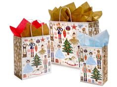 two paper bags with different designs and decorations on them, one has a red bow