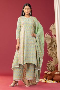 Mint green asymmetric kurta with spring block print and scallop lace work. Paired with printed palazzo and printed, scallop hem dupatta.
Component: 3
Pattern: Printed
Type Of Work: Block Print
Neckline: Scallop
Sleeve Type: Scallop
Fabric: Kurta and Palazzo: Cotton Cambric, Dupatta: Cotton Mulmul
Color: Green
Other Details: 
Floral print
Printed dupatta
Occasion: Puja - Aza Fashions Green Cotton Kurta With Dupatta, Bollywood Style Green Palazzo Set With Traditional Drape, Green Palazzo Set With Sheer Dupatta In Traditional Drape, Green Dupatta With Printed Motifs For Spring, Anarkali Green Sharara For Summer, Green Anarkali Sharara For Summer, Fitted Green Sharara For Spring, Green Sets With Dupatta For Spring, Green Summer Sets With Printed Motifs