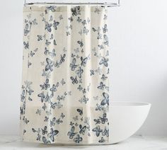 a shower curtain with blue butterflies on it