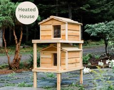 a wooden bird house with the words heated house above it