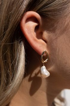 A modern play on the classic pearl earring. This earring has a big personality with an organic shaped, gold filled stud and a large fresh water pearl dropping below. Dress it down or dress it up, this earring is for any occasion! Binah; precious, rare, & weighty. She is Binah. 1.75" long Fresh Water Pearls Nickel Free Hypoallergenic Designed and handmade at Adorn's storefront in Steamboat Springs, CO Care: Avoid salt water, chlorine and harsh chemicals. Polish regularly with a jewelry cloth to i Drop Pearl Pendant Earrings, Everyday Teardrop Pearl Pendant Earrings, Modern Drop Pearl Earrings With Pearl Charm, Modern Drop Pearl Earrings With Charm, Teardrop Baroque Pearl Earrings For Everyday, Modern Drop Pearl Charm Jewelry, Chic Pearl Pendant Earrings For Gift, Chic Pearl Pendant Earrings As Gift, Everyday Teardrop Baroque Pearl Earrings