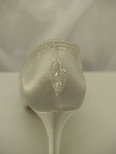 a pair of white wedding shoes with crystal beading