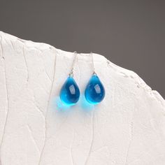 "These Small light blue teardrop earrings are made of glass in lampwork technique. The earrings hooks are sterling silver and are hypoallergenic. These unique and beautiful earrings are like water drops frozen in glass! They are simple and elegant, very lightweight and comfortable to wear, perfect for everyday wear and for special occasions. 💕 You will definitely receive lots of compliments on your new earrings, everybody loves them, and you'll love them too! Dimensions: total length about 1 1/ Blue Pear-shaped Teardrop Earrings, Turquoise Teardrop Drop Earrings With Ear Wire, Hypoallergenic Teardrop Drop Earrings As Gift, Hypoallergenic Teardrop Drop Earrings For Gift, Light Blue Sterling Silver Teardrop Earrings, Blue Teardrop Pendant Earrings As Gift, Blue Teardrop Drop Earrings, Blue Teardrop Earrings With Ear Wire, Blue Long Drop Teardrop Earrings Gift