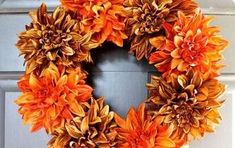 an orange wreath is hanging on the front door